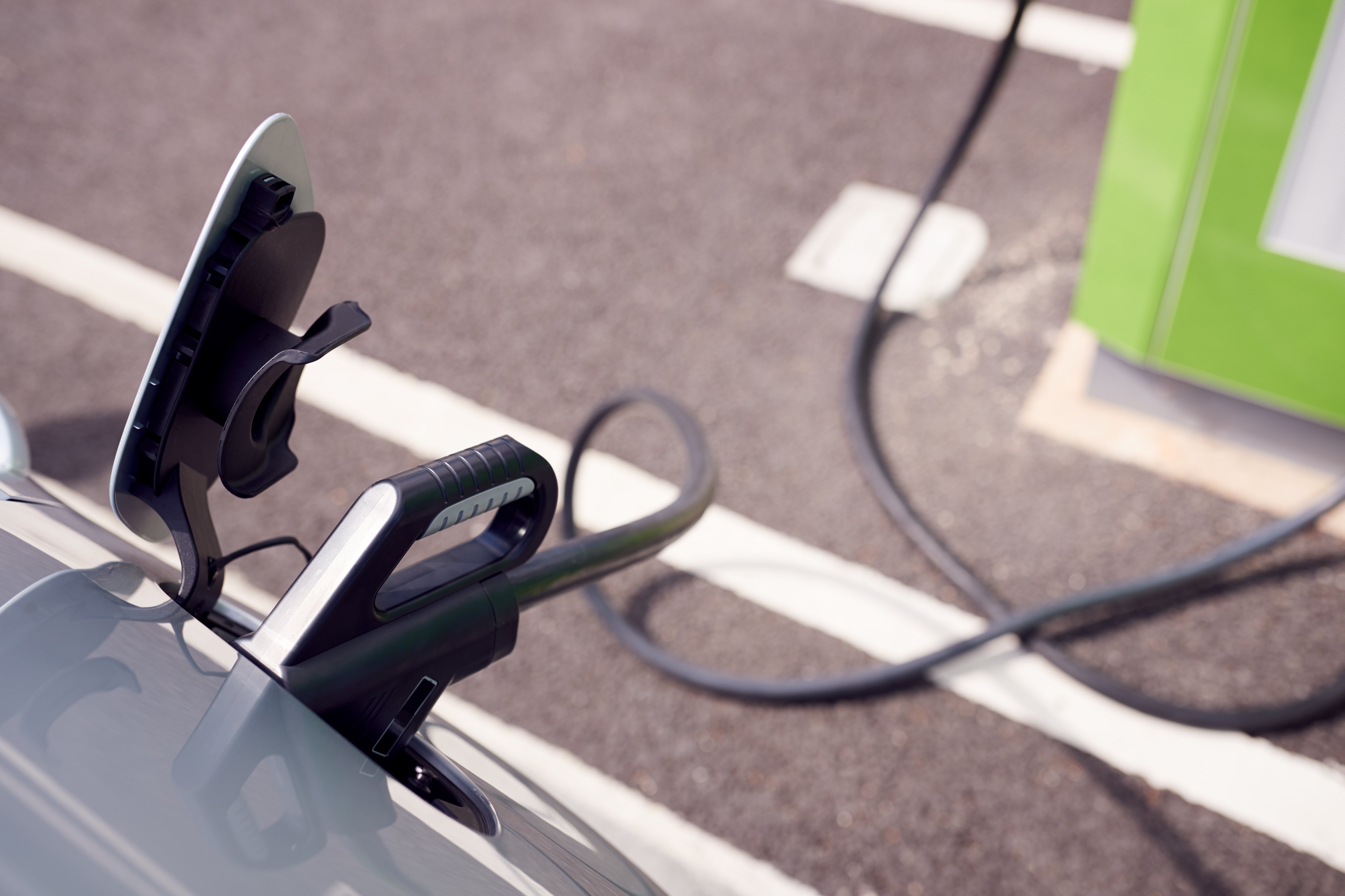 close-up-of-power-cable-charging-electric-car-outd-2021-08-26-16-15-20-utc