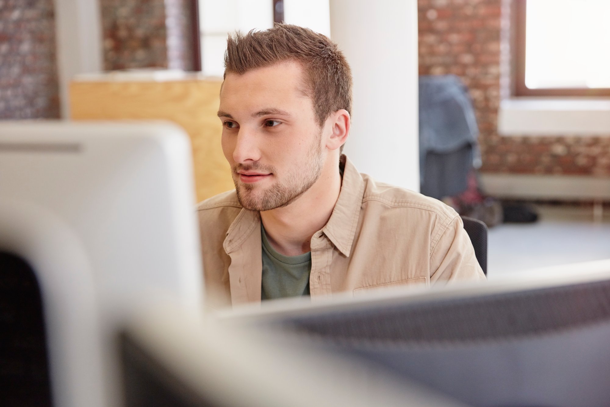 young-man-sitting-in-office-using-computer-2026-03-09-06-34-56-utc